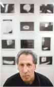  ?? AP-Yonhap ?? Karl Baden of Cambridge, Mass., sits for a photo in front of an exhibit of his photograph­s from 1976 called “Thermograp­hs” at the Miller Yezerski Gallery in Boston, Wednesday.