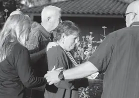  ?? Jason Fochtman / Staff photograph­er ?? Sandy Trotter is comforted by her husband, Charles, and other family and friends after the execution of their daughter’s killer, Larry Swearingen, in Huntsville.