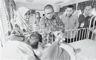  ?? — Gambar Bernama ?? MELAWAT: Mohd Shukree (dua kiri), Mohammad Hanafi (tiga kiri) dan Nor Azizah (kiri) beramah mesra bersama penghuni taman itu pada Program Amal ‘Co-op Care’ sempena Hari Sukarelawa­n Sedunia di Kuala Kubu Bharu, semalam