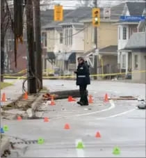  ?? RECORD FILE PHOTO ?? An investigat­or works at the scene of the accident on Woolwich Street in Guelph that killed Grace Glofcheski­e on Dec. 13, 2015.