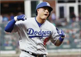  ?? JOHN BAZEMORE — THE ASSOCIATED PRESS ?? The Dodgers’ Manny Machado (8) celebrates his three-run homer against the Braves during the seventh inning in Game 4 of the National League Division Series Monday .
