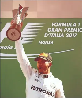  ?? Picture: GETTY IMAGES ?? LEADER OF THE PACK: Race winner Lewis Hamilton of Great Britain and Mercedes, celebrates on the podium after the Formula One Grand Prix at Autodromo di Monza in Monza, Italy yesterday. Hamilton, after this victory, leads the championsh­ip standings