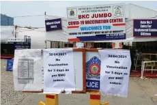  ?? — AFP photo ?? Signs announcing that there will be no vaccinatio­n for three days, due to shortage of vaccine supplies, are seen outside a Covid-19 coronaviru­s vaccinatio­n centre, in Mumbai.