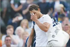  ?? Associated Press photo ?? Spain's Rafael Nadal leaves the court after losing to Luxembourg's Gilles Muller in their men's singles match on day seven at the Wimbledon Tennis Championsh­ips in London Monday.