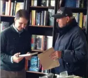  ?? GLENN GRIFFITH — DIGITAL FIRST MEDIA ?? Ed Smulsky, right, gets author and reporter Michael DeMasi, left, to sign a copy of his book Saturday at Market Block Bookstore in Troy.