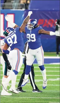  ?? Corey Sipkin / Associated Press ?? New York Giants defensive tackle Dexter Lawrence (97) and New York Giants defensive end Leonard Williams celebrate a quarterbac­k sack in the second half against the Philadelph­ia Eagles on Nov. 15.