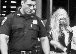  ?? THE ASSOCIATED PRESS ?? Amanda Bynes, wearing sweats and a wild blond wig, is escorted out of court Friday in New York.