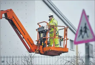  ??  ?? DAMAGE CONTROL: Workmen carry out repairs at Oxgangs Primary School in Edinburgh, one of 17 schools across the capital which were closed following building safety fears. Picture: Jeff J Mitchell/Getty Images.