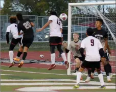  ?? RICK PECK/SPECIAL TO MCDONALD COUNTY PRESS ?? McDonald County’s Jeobany Marcos (13) heads in a corner kick for the Mustangs’ lone goal during McDonald County’s 3-1 loss to Neosho in the opening round of the Missouri Class 3, District 12, Soccer Tournament on Oct. 30 at Carl Junction High School.