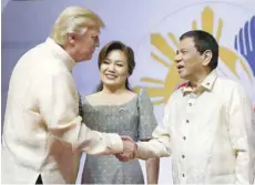  ?? — Reuters ?? US President Donald Trump with his Philippine­s counterpar­t Rodrigo Duterte as he arrives for the gala dinner marking Asean’s 50th anniversar­y in Manila on Sunday.
