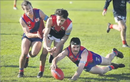  ?? Picture: PAUL CARRACHER ?? DESPERATIO­N: Kalkee and Laharum players, from left Jasper Gunn, Patrick Lattanzio and Matt Magee fight for a loose ball at Kalkee. Kalkee will play finals this weekend while Laharum will look to next season.