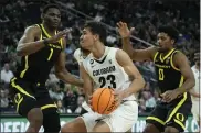  ?? JOHN LOCHER — THE ASSOCIATED PRESS ?? Colorado forward Tristan da Silva drives against Oregon center N’faly Dante, left, and guard Kario Oquendo during the second half of the Pac-12 championsh­ip on Saturday in Las Vegas.