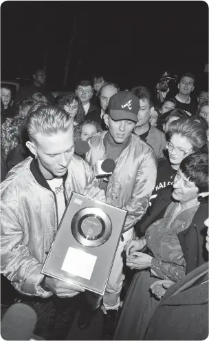  ??  ?? Luke Goss presents a records to Pat Gaskin, the Hospital manager as a memento of their visit