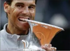  ?? GREGORIO BORGIA — THE ASSOCIATED PRESS ?? Spain’s Rafael Nadal bites the trophy after beating Germany’s Alexander Zverev in the final match of the Italian Open tennis tournament, in Rome, Sunday. Nadal won 6-1, 1-6, 6-3.