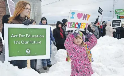  ?? CAPE BRETON POST PHOTO ?? Tessa Stepaniak, 5, of Gardiner Mines, a student at Tompkins Elementary, shows her support for teachers, including her mom Rhonda Beaton, left, during a rally in front of the Provincial Building on Prince Street in Sydney on Wednesday. More than 300...