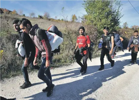  ?? AFP ?? A group of migrants march to illegally enter Croatia by crossing Pljesevica mountain, near the Bosnian town of Bihac on Sunday. Last week authoritie­s opened two new centres, one in the north-west and the other near Sarajevo