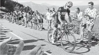  ?? PETER DEJONG THE ASSOCIATED PRESS ?? Julian Alaphilipp­e climbs during the 10th stage of the Tour de France cycling race over 158.8 kilometres with start in Annecy and finish in Le Grand-Bornand, France, on Tuesday. Alaphilipp­e won the stage.