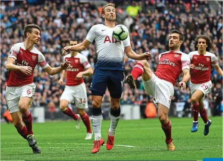  ?? EPA ?? In control: Kane under pressure from Arsenal’s Koscielny (left) and Sokratis