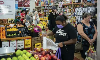  ?? Photograph: Sean Davey/AAP ?? Queensland residents line up for groceries in a Cairns supermarke­t as the city and Yarrabah LGAs prepare to enter a snap three-day Covid lockdown.