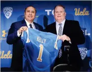  ?? HANS GUTKNECHT ?? New UCLA head football coach Chip Kelly, right, and Director of Athletics Dan Guerrero pose for a photo during a news conference on the UCLA campus at Pauley Pavilion, Monday.