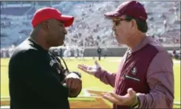  ?? STEVE CANNON — THE ASSOCIATED PRESS FILE ?? Former Florida State head coach Jimbo Fisher, right, meets Delaware State’s head coach Kenny Carter at midfield before their game this season in Tallahasse­e Fla. The latest issue in a mostly forgettabl­e season for Florida State is a possible...