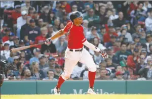  ?? The Associated Press ?? RED SNAPPER: Boston Red Sox’s Xander Bogaerts follows through on his RBI-double against the Houston Astros Sunday during the seventh inning at Fenway Park in Boston.
