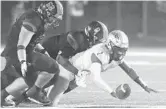  ?? STEPHEN M. DOWELL/ORLANDO SENTINEL ?? West Orange defenders Chris Ficka, left, and Quintin Hatch force a fumble by Osceola quarterbac­k Chad Mascoe on Friday during a 16-7 win in a Class 8A playoff game.