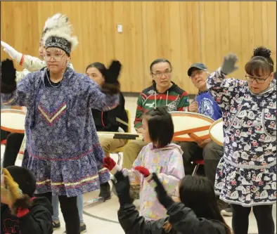  ?? ?? PERFORMING (below)— Tenth grader Harriet Steve, in the blue qaspeq and nuskutuk headdress, dances next to bilingual teacher Pauline Richardson.