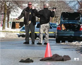  ?? STAFF PHOTOS BY MATT WEST ?? ‘EXTREMELY RARE’: Newton Police investigat­e at the scene of a daytime stabbing on Watertown Street in West Newton yesterday. A 36-year-old man was taken into custody. The victim was rushed to an area hospital.