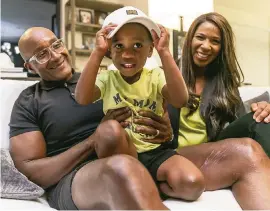  ?? MATIAS J. OCNER mocner@miamiheral­d.com ?? Symeria Hudson, president and CEO of Chapman Partnershi­p, her husband, Gary Hudson, and their 3-year-old son, Garrett, relax at their Fort Lauderdale home.