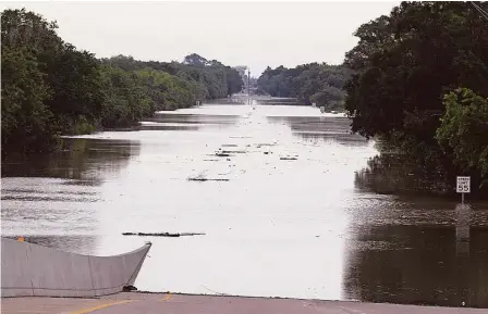  ?? James Nielsen / Houston Chronicle ?? Texas 6 near Interstate 10 remained closed due to high water Sunday, when more rains added to an already-soggy region.