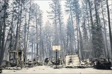  ?? Marcus Yam Los Angeles Times ?? THE REMAINS of a house destroyed by the deadly Camp fire stand eerily amid the surroundin­g forestry last week in Paradise, Calif.