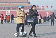  ?? PROVIDED TO CHINA DAILY ?? People wear masks at Tian’anmen Square in Beijing on Monday, as smog returned to the city after a short time of relief.