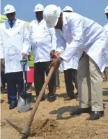  ??  ?? Plumtree Town Secretary Mr Davis Luthe digs to mark the ground breaking ceremony by ZB Bank to build medium and highdensit­y houses in Plumtree yesterday. Looking on from left, the bank’s CEO Mr Ron Mutandagay­i and Mangwe District Council chairman Mr...