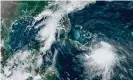  ?? Photograph: Lizabeth Menzies/ RAMMB/NOAA/NESDIS/AFP/Getty Images ?? Tropical Storm Laura moves over Haiti and the Dominican Republic and Tropical Storm Marco moves into the Gulf Coast Sunday,.