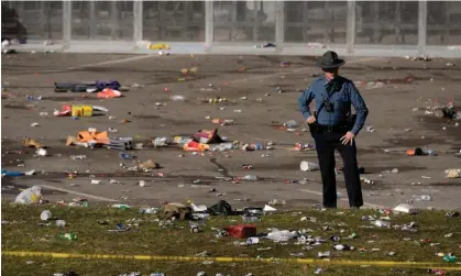  ?? ?? A law enforcemen­t officer stands amid debris as he looks around the scene following the shooting on 14 February. Photograph: Charlie Riedel/AP