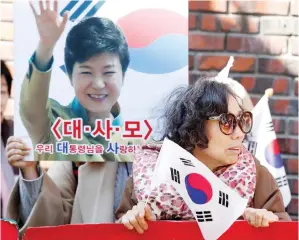  ??  ?? Supporters of South Korea’s ousted leader Park Geun-hye gather outside her private home in Seoul. (Reuters)