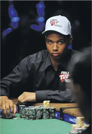  ?? ROBYN BECK / AFP / GETTY IMAGES ?? Phil Ivey plays a hand at the 2009 World Series of Poker in Las Vegas. The poker champion has lost at the British Supreme Court, which ruled he was cheating when he asked dealers to rotate cards.