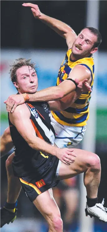  ?? Picture: JUSTIN KENNEDY ?? NT Thunder's Jake Roe-Duggan (left) gets caught up with Sydney University’s Timothy Barton in an aerial battle during last night’s NEAFL premiershi­p clash at TIO Stadium