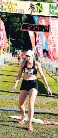  ??  ?? Canadian Karen Warrendorf comes across the finish line to win the women’s section of the 2016 Reggae Marathon in 3:39:15 in Negril, Westmorela­nd, last Saturday.