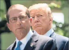  ?? NICHOLAS KAMM — AFP/GETTY IMAGES ?? Health and Human Services Secretary Alex Azar delivers remarks on reducing drug costs as President Donald Trump looks on at the White House on Friday.