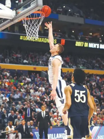  ??  ?? Freshman guard Donte DiVincenzo, scoring Thursday in Buffalo, N.Y., against Mount St. Mary’s, finished with 21 points off the bench for defending national champion Villanova. Elsa, Getty Images