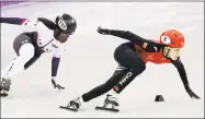  ?? David J. Phillip / Associated Press ?? China’s Kexin Fan, right, leads Maame Biney of the U.S. in their ladies’ 500 meters short-track speedskati­ng heat at the 2018 Winter Olympics on Saturday.