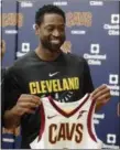  ?? TONY DEJAK — ASSOCIATED PRESS ?? Dwyane Wade holds up his new Cavs jersey during a news conference Sept. 29 in Independen­ce.