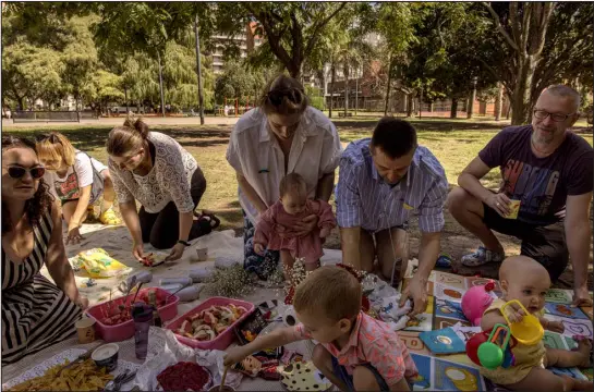  ?? ?? Maria Rashka, husband Pavel Kostomarov and daughter Alexandra, who was born in August, celebrate their wedding with friends last month at a park in Buenos Aires, Argentina. Pregnant Russians have been flocking to the South American country, where obtaining citizenshi­p is relatively easy if your child is born there.