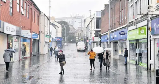  ?? GAYLE MARSH ?? Shoppers on Caroline Street in Bridgend town centre during the local lockdown