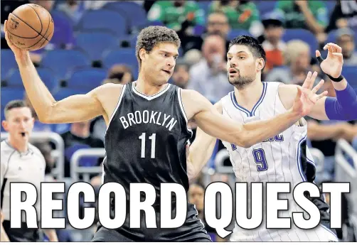  ?? AP ?? SUM SEASON: Brook Lopez, who is closing in on the Nets’ all-time scoring record — currently held by Buck Williams — plays keep-away with the Magic’s Nikola Vucevic as he scores 10 points in Brooklyn’s 115-107 loss Thursday night in Orlando, Fla.