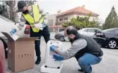  ?? BILAL HUSSEIN/AP ?? Two members of Baytna Baytak unpack an oxygen machine to be given to an elderly COVID-19 patient last month in Beit Shebab, a village north of Beirut.