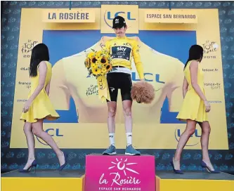  ?? ASSOCIATED PRESS FILE PHOTO ?? Britain’s Geraint Thomas celebrates after the 11th stage of the Tour de France as so-called “podium girls” leave the platform. The role of the girls has been called into question.