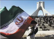  ?? Vahid Salemi / Associated Press ?? A boy carries an Iranian flag in a rally to celebrate the 41st anniversar­y of the 1979 Islamic Revolution in Tehran.